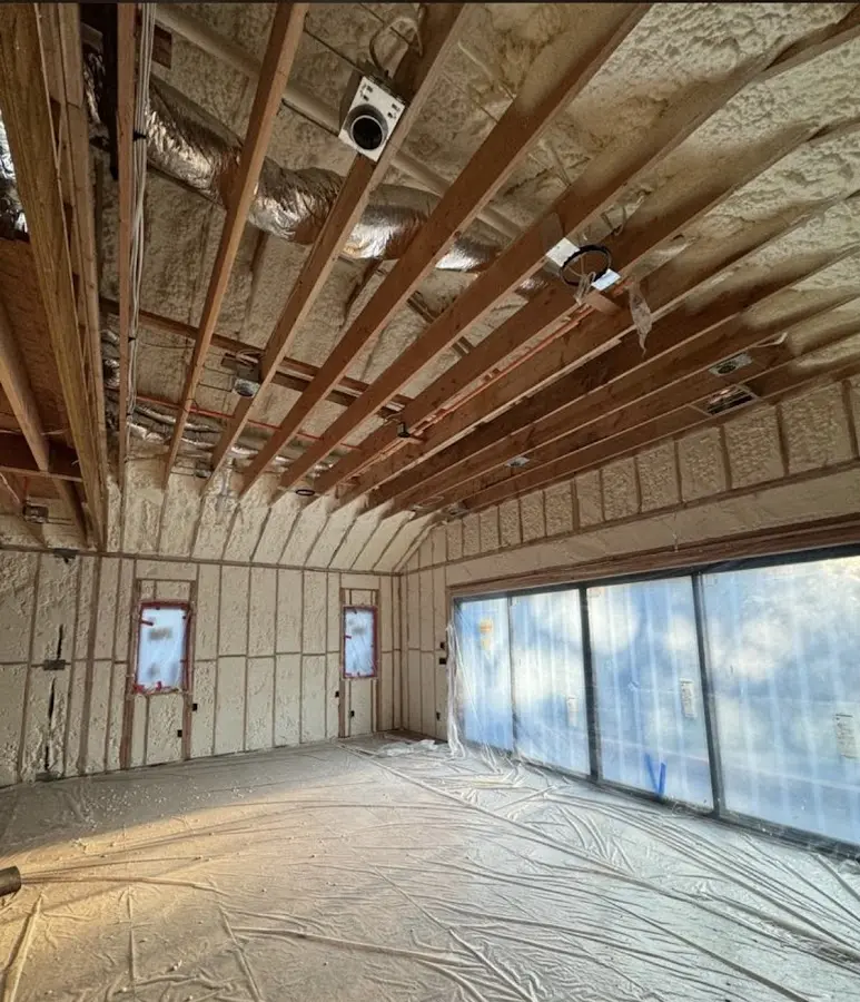 Interior walls and ceiling insulated with spray foam during new construction in Brenham